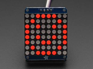 Adafruit Small 1.2" 8x8 Red LED Matrix w/I2C Backpack assembled and powered on. A red graphic smiley is displayed.