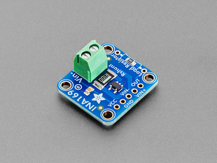 Angled shot of blue, square-shaped breakout board with a green terminal block.