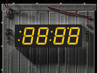 Huge yellow 7-segment clock display with all segments lit