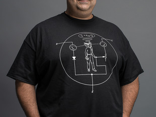 Man wearing black t-shirt with white NPN transistor diagram with a man inside the diagram