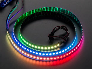 Adafruit NeoPixel Digital RGB LED Strip wired to a microcontroller, with all the LEDs in a rainbow