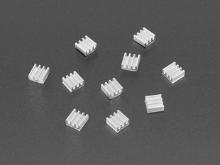 Scattered pile of ten square, aluminum heat sink with four fins.