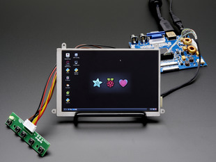 Angled shot of an assembled 5.6" Display & Audio Kit. The HDMI screen displays a desktop image including the Adafruit logo, the Raspberry Pi logo, and a pink heart. 