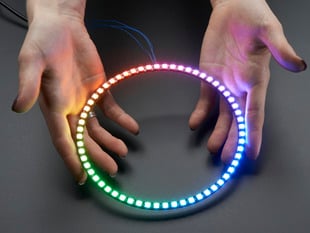 Hand holding NeoPixel Ring with 60   x 5050 RGB LED, lit up rainbow