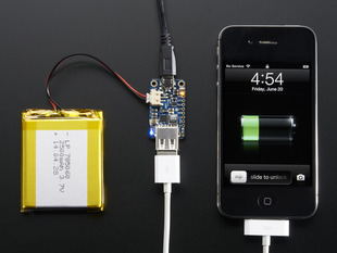 Top view of PowerBoost 500 Charger connected to a battery and a white iPhone charger charging an iPhone. 