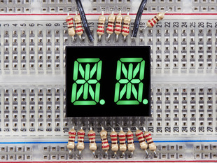 green Dual Alphanumeric Display module wired to breadboard, all segments lit