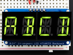 Assembled Quad Alphanumeric Display with yellow-green display showing "ABCD"