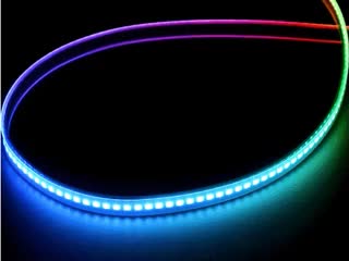 Shot of lightly coiled LED strip glowing rainbow colors.