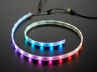 Adafruit NeoPixel Digital RGB LED Strip wired to a microcontroller, with all the LEDs in a rainbow