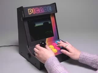 Video of a white woman wearing a light pink wool sweater playing Donkey Kong Country.