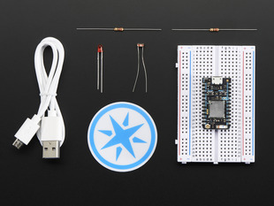 Top down view of a Particle Photon on a half-sized breadboard and kit components. 