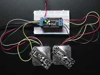 Video of 2 steppers spinning with rectangular black board on them powered by a DC Motor + Stepper FeatherWing Add-on For All Feather Boards