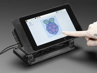 Angled shot of assembled Smarti Pi Touch display. A finger presses on the touchscreen display, which shows a raspberry logo.