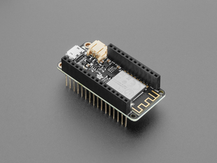 Angled shot of black, rectangular microcontroller with stacking headers.