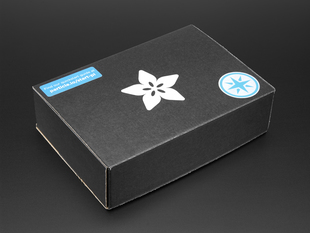 Angled shot of a black box with the white Adafruit star-flower logo.