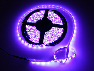 Spool of flexible LED strip lit up purple