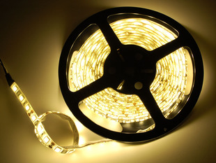 Spool of flexible LED strip lit up warm white