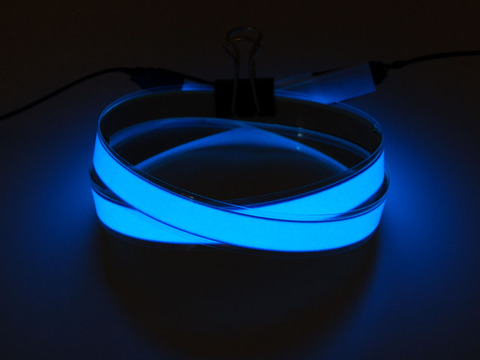 Coil of lit blue Electroluminescent Tape Strip 