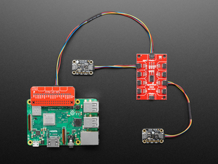 Top down view of aPi connected to red rectangular board. Two small black rectangular boards connected to the red rectangular board via JST plugs. 