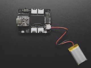 Top view demo of a manicured finger pressing a reset button on an extension board. The OLED delivers a readout display and reports the memory size.