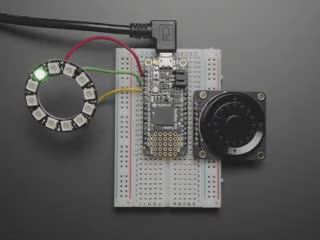 Video of Rotary Navigation Encoder Breakout soldered and assembled on a breadboard with a NeoPixel ring and Feather M4. A white hand touches the rotary knob, lighting up NeoPixel LEDs.