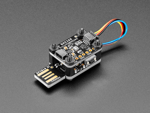 Angled shot of a USB key-shaped PCB with a sensor board stacked on top via black nylon screws.