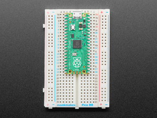 Half-size breadboard with a soldered skinny green microcontroller.