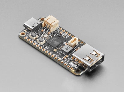 Angled shot of black rectangular microcontroller with USB C and USB A connectors at both ends.