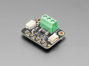 Angled shot of DC current monitor breakout board with green terminal block.