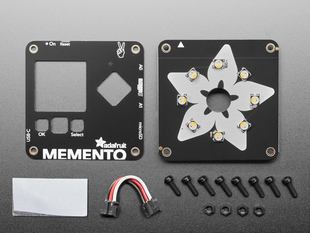 Overhead shot of two square-shaped PCB boards for a DIY camera above eight black plastic screws and four black plastic hex nuts with 3pin to 3pin JST PH cable and adhesive sticker.