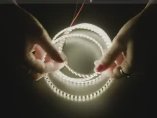 Additional video of hand futzing with a double-sided LED strip emitting natural white LEDs.