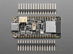 Overhead shot of rectangular dev board between two pieces of 16-pin header.