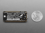 Back of black, rectangular datalogging board next to US quarter for scale.