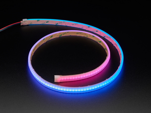 Angled shot of LED strip in a spiral, emitting pink and blue colors.