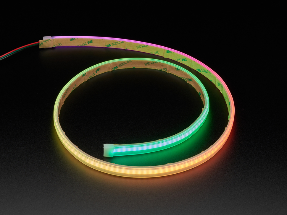 Angled shot of LED strip in a spiral, emitting yellow and green colors.