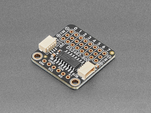 Angled shot of black, square-shaped, chain-able sensor breakout board.