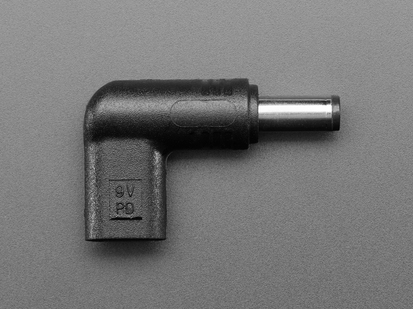 Overhead shot of barrel-jack-to-USB-C-socket right angle adapter, showing 9V.