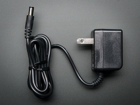 Top view of a black power supply with barrel jack.