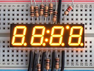 Small yellow 7-segment clock display with all segments lit