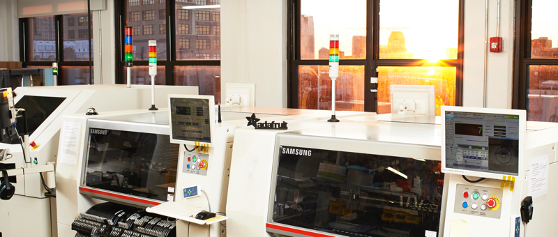 Samsung electronic assembly equipment line with New York City sunset in background